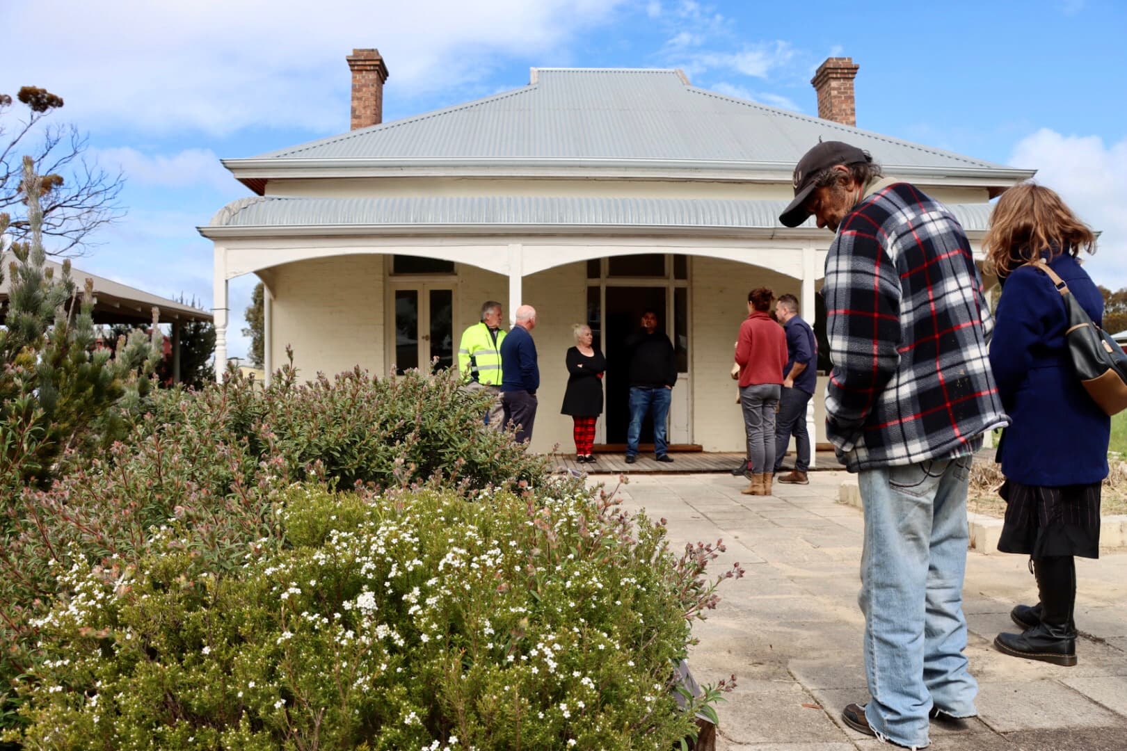 Group in wandoo woodland looking at large map