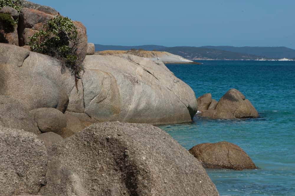 Large granite boulders in the ocean