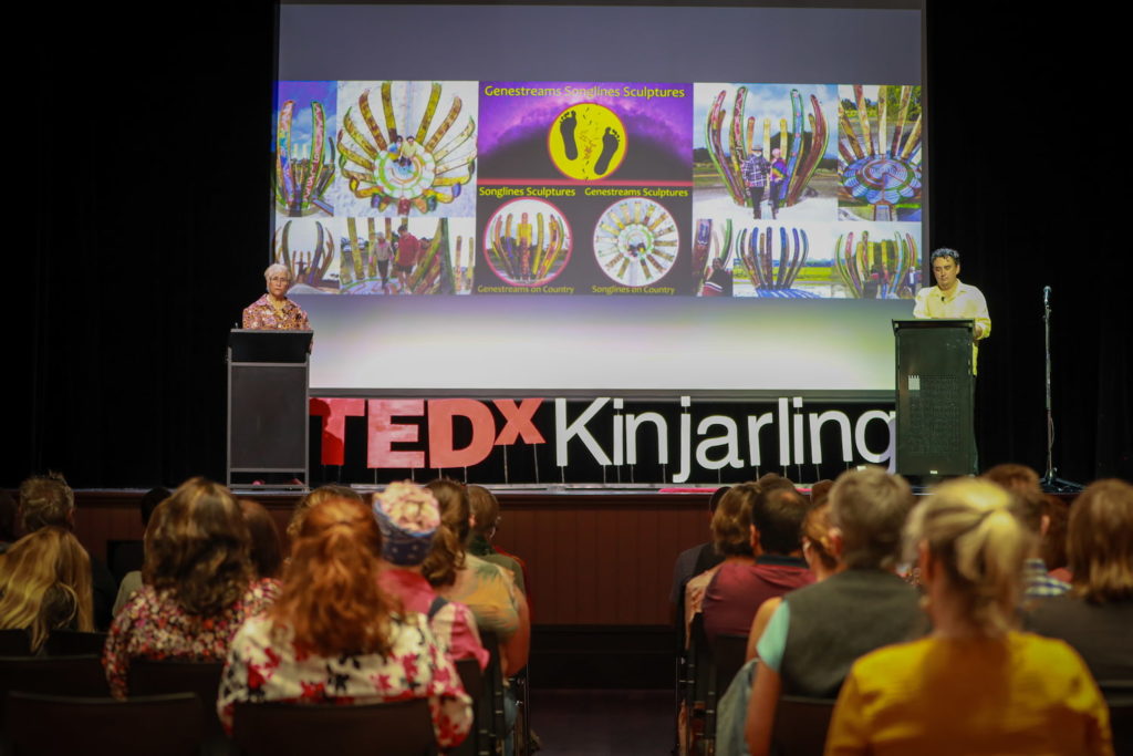 Aunty Carol and artist Ben Beeton presenting the Gondwana Link Genestreaming Journey Sculptures on Noongar Boodja, at the 2022 TEDxKinjarling event in Albany