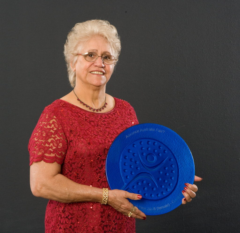 Aunty Carol Pettersen holding her  NAIDOC 2008 Female Elder of the Year Award. 