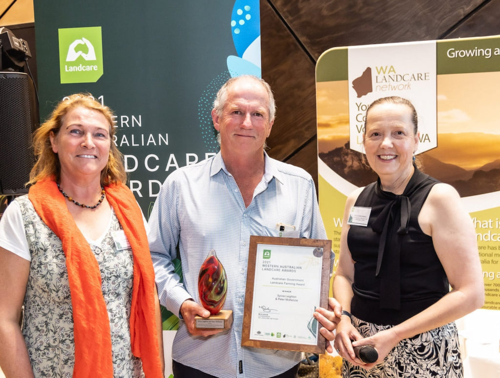 Image of Sylvia Leighton (left) and Peter McKenzie receiving the Australian Government Landcare Farming Award 2021 from Cec McConnell, WA Commissioner for Soil and Land Conservation, at the WA Landcare Network Awards night.