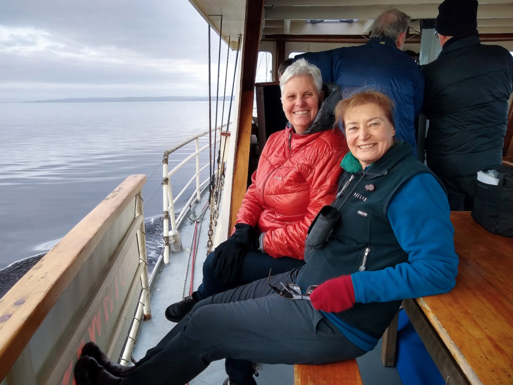 Image of Margaret Robertson with Cathie Plowman, on a July 2023 trip up the Gordon River in south-west Tasmania.