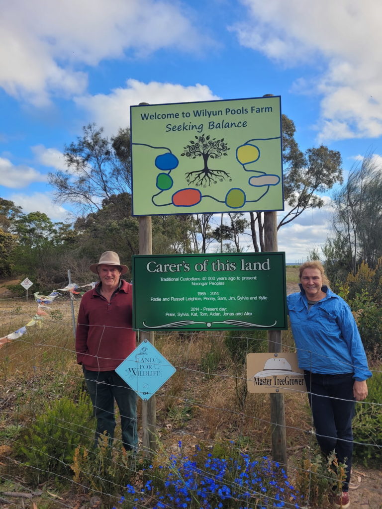 Image of Peter McKenzie and Sylvia Leighton at the entrance to their farm.

